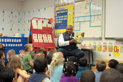 W.C. Blackmon reads the Three Little Pigs to 60 kindergarten students at J. Michael Conley Elementary School.