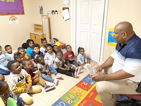 Bobby Blackmon reads in braille to children at the My Children Childcare and Preschool in Tallahassee, Florida. Photo: Andrew MillerPicture